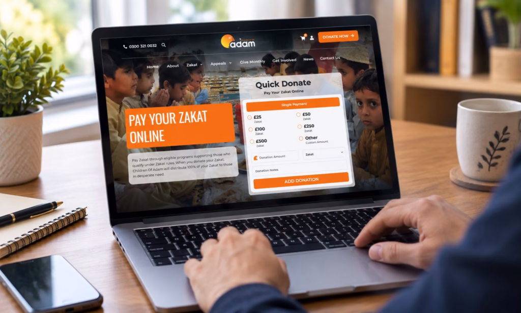 A person using a laptop to make an online donation on a charity website.